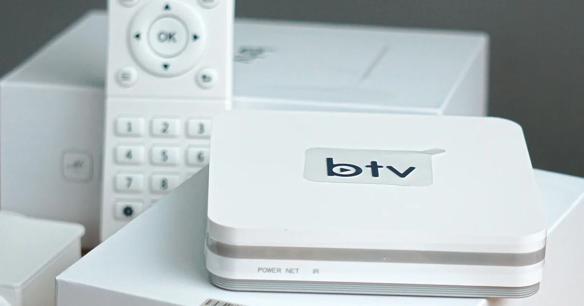 Modern smart TV control equipment with remote control and streaming device on a table