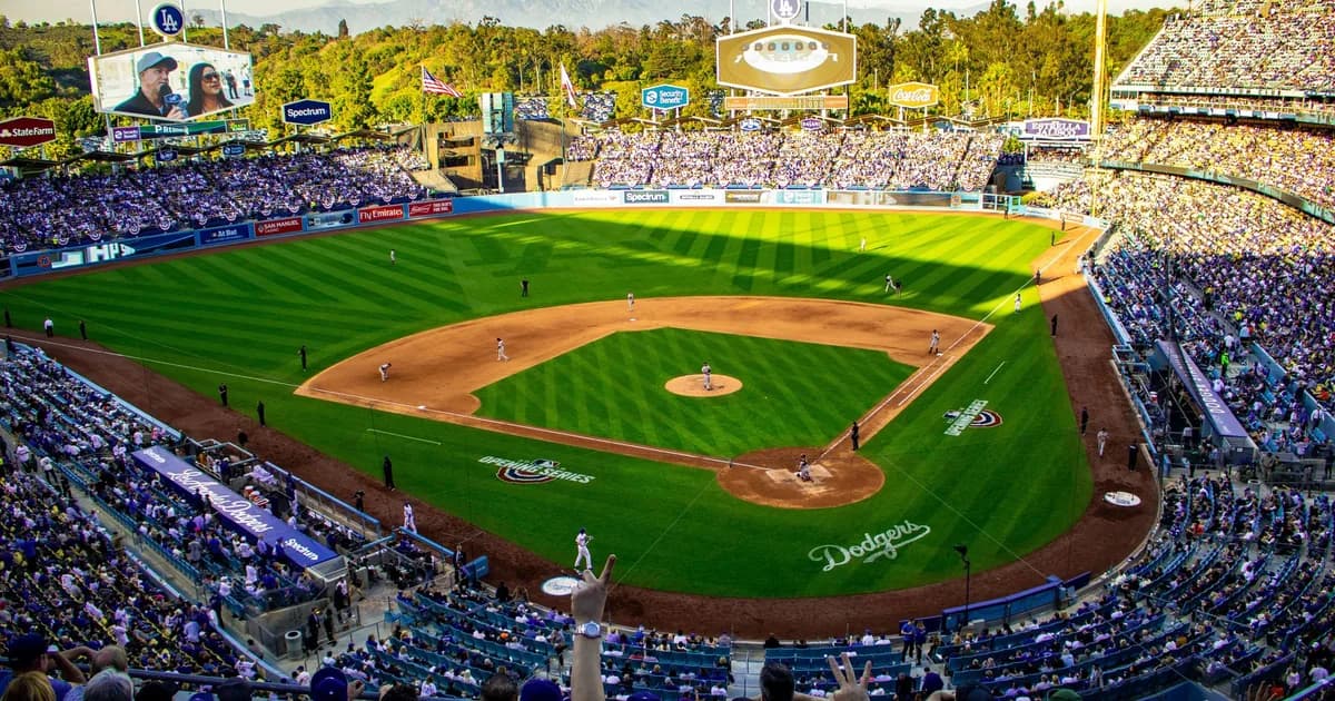 Crowded baseball stadium during a live game with the field and grandstands visible